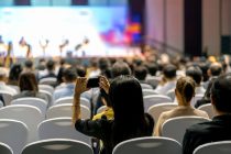 rear-view-audience-listening-speakers-stage-conference-hall-seminar-meeting-3
